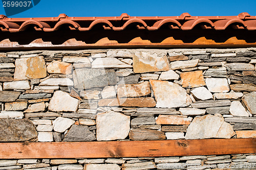 Image of Wall built of stones. Sun light