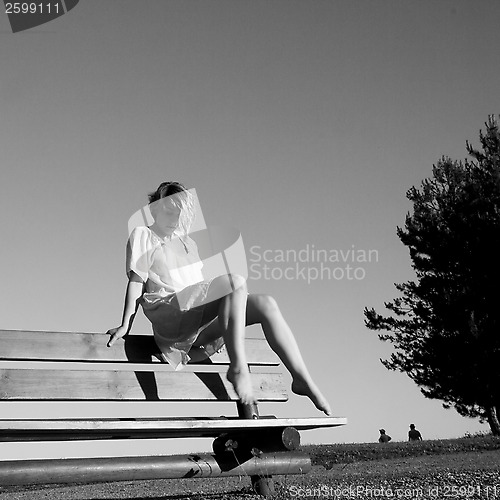 Image of Dancer on a bench in a park.