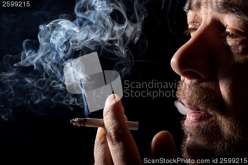 Image of Portrait man smoking cigarette