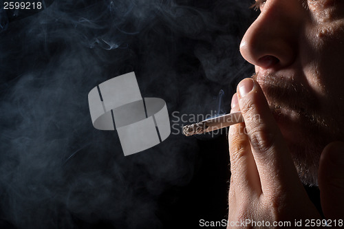 Image of Portrait man smoking cigarette