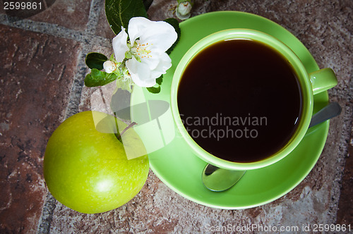 Image of Cup of tea with an apple