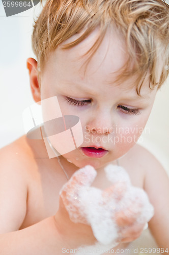 Image of The little boy bathes in bathing with foam
