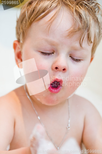 Image of The little boy bathes in bathing with foam