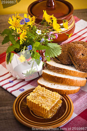 Image of Still life with honeycombs, flowers and pot 