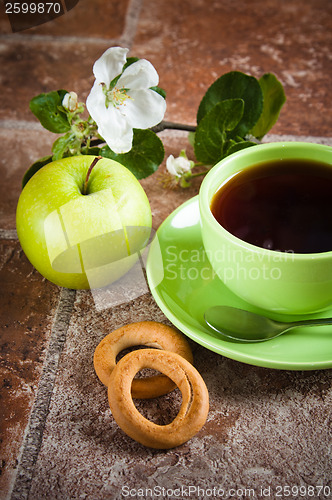 Image of Cup of tea with an apple