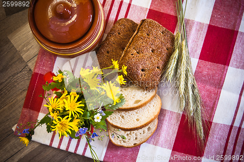 Image of Still life with bread, flowers and pot