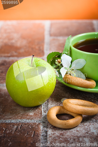 Image of Cup of tea with an apple