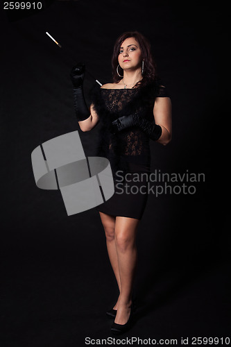 Image of Young woman in retro dress on a black background