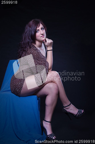 Image of Young woman in sexy dotted mini dress