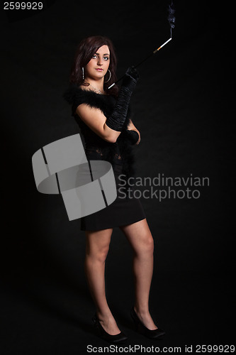 Image of Young woman in retro dress on a black background