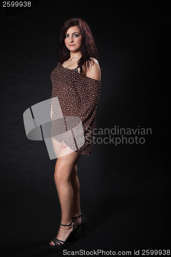 Image of Young woman in sexy dotted mini dress