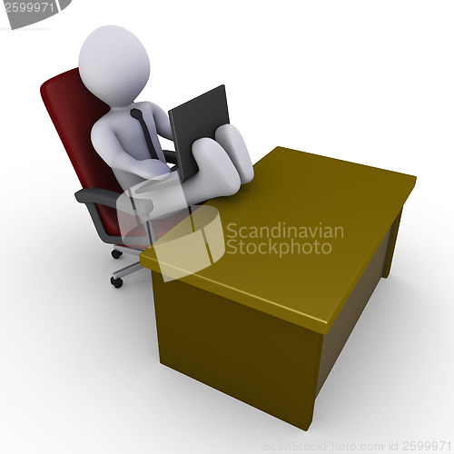 Image of Businessman with feet on desk working with laptop