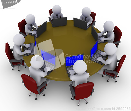 Image of Businessmen around table with laptops