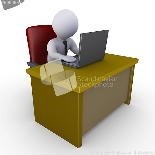 Image of Businessman in office with laptop