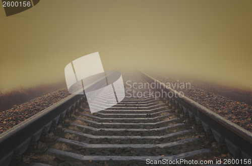 Image of grunge railroad to horizon in fog