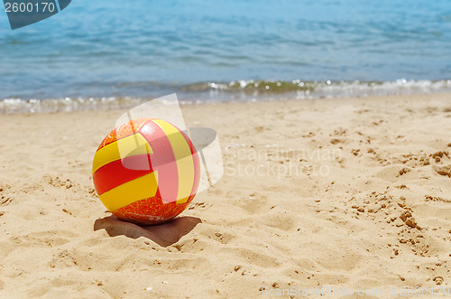 Image of ball on sand near sea