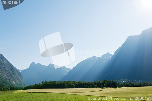 Image of Sun rays in mountains lighting the valley, Norway