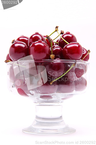 Image of Ripe fresh cherry in the glass isolated on white background