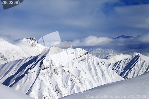 Image of Off-piste slope and cloudy mountains at nice evening