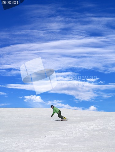 Image of Snowboarder on ski slope and blue sky