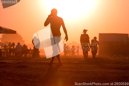 Image of Golden sunset with many people