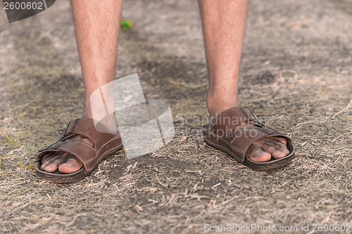 Image of Feet of a sad farmer without crop