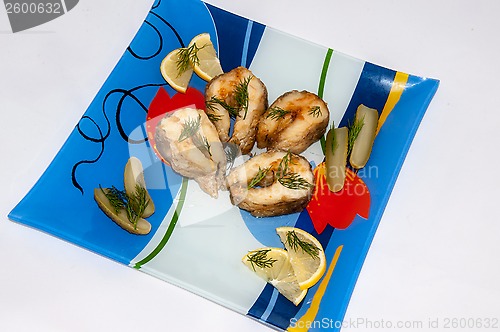 Image of Fried fish with herbs and lemon juice.