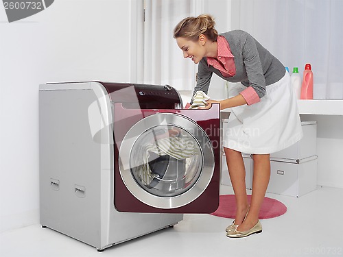 Image of young woman doing laundry