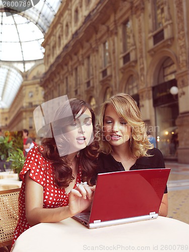 Image of happy businesswomen with laptop