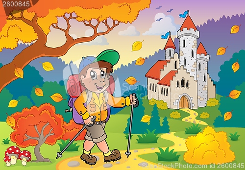 Image of Hiker walking on path near castle