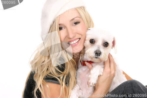 Image of Sitting girl cuddling a dog