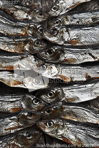Image of Plenty of small dried fishes on a stack