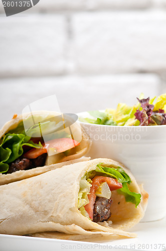 Image of kafta shawarma chicken pita wrap roll sandwich