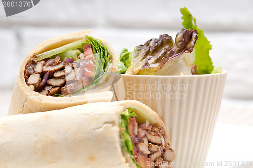 Image of kafta shawarma chicken pita wrap roll sandwich