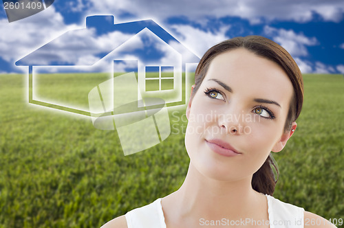 Image of Woman and Grass Field with Ghosted House Figure Behind