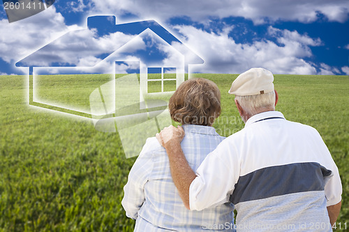 Image of Senior Couple Standing in Grass Field Looking at Ghosted House