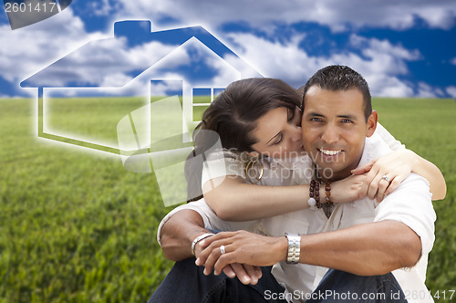 Image of Hispanic Couple Sitting in Grass Field with Ghosted House Behind