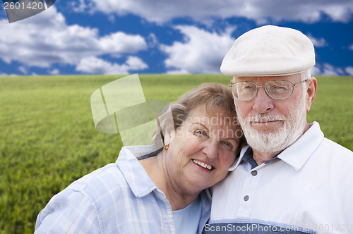 Image of Loving Senior Couple Standing in Grass Field 