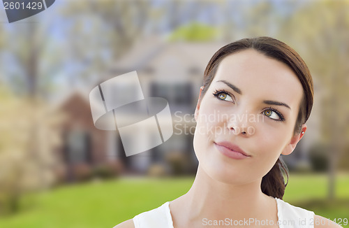 Image of Thoughtful Mixed Race Woman In Front of House