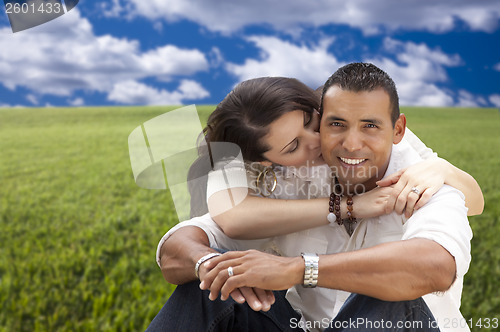 Image of Hispanic Couple Sitting in Grass Field