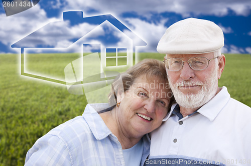 Image of Senior Couple Standing in Grass Field with Ghosted House Behind