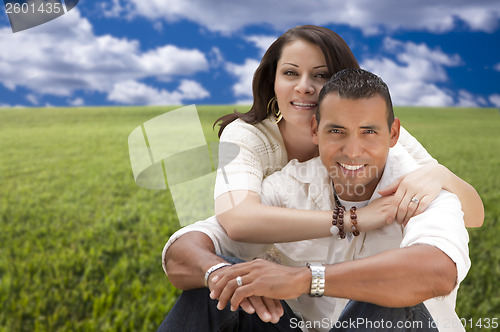 Image of Hispanic Couple Sitting in Grass Field