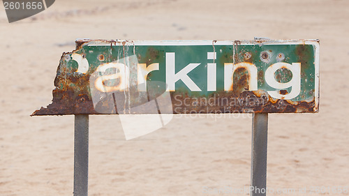 Image of Old rusty parking sign