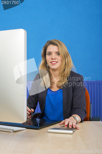 Image of Young woman behind a computer