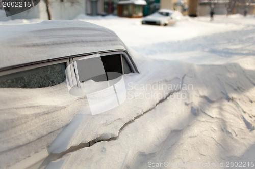 Image of White old car covered with snow