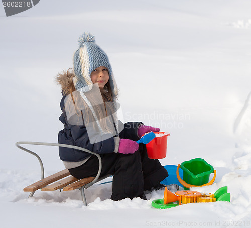 Image of Little girl playing in snow