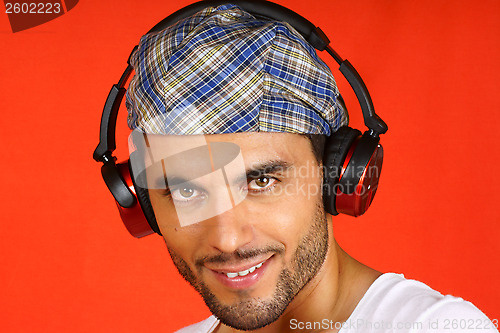 Image of 30 years old man with beret and earphones