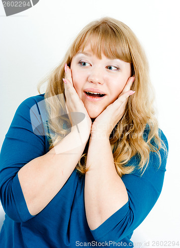 Image of Portrait of a surprised young blonde woman