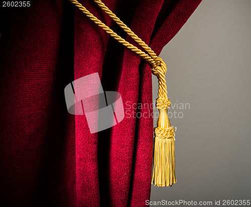 Image of Red velvet curtain with tassel