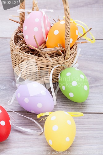 Image of colorful easter egg decoration on wooden background